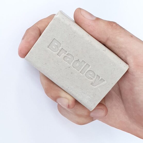 Close up of a hand holding a Bradley heavy-duty soap bar